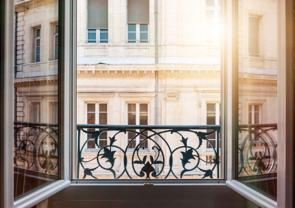 Beautiful sunshine reflecting off the windows of the tenement and streaming into the apartment across the street